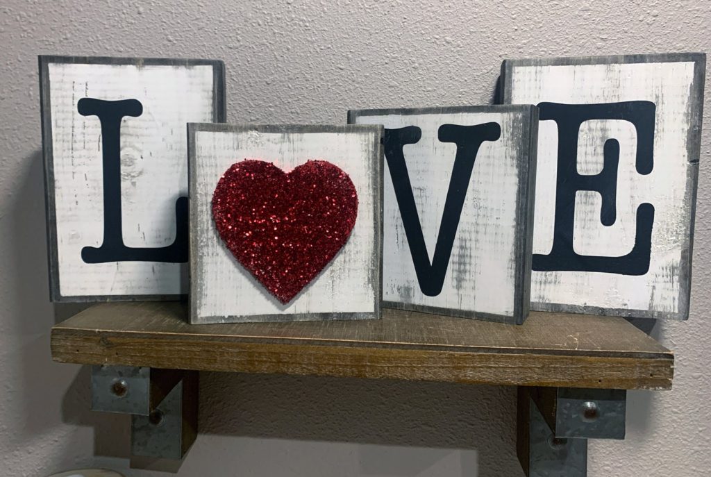 Farm house style block letter decor spelling LOVE. 
