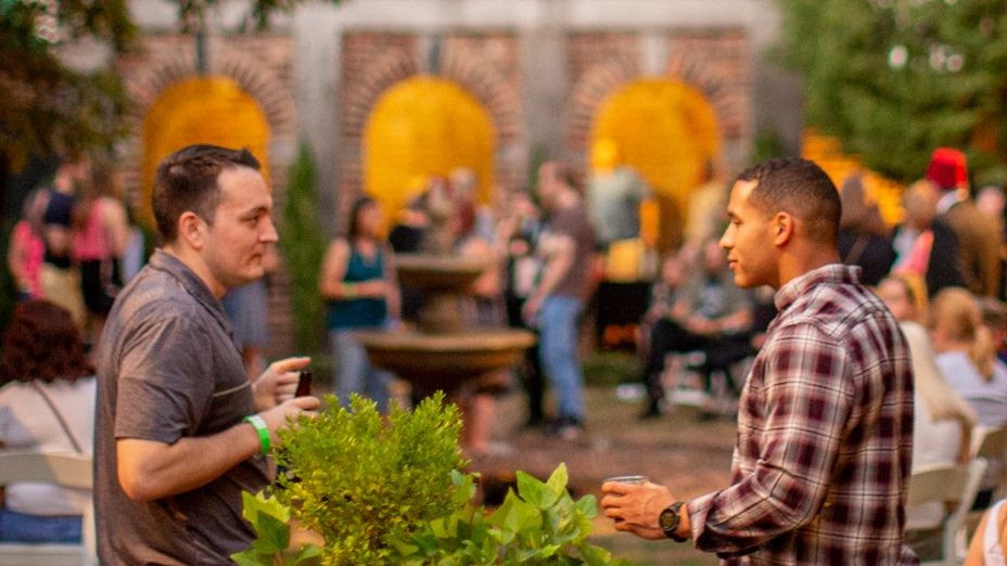 Two men socializing at a party.