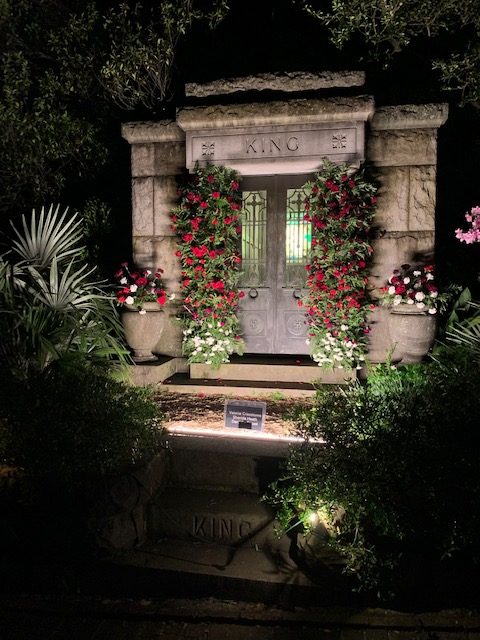 Beautifully decorated mausoleum with lights and flowers. 