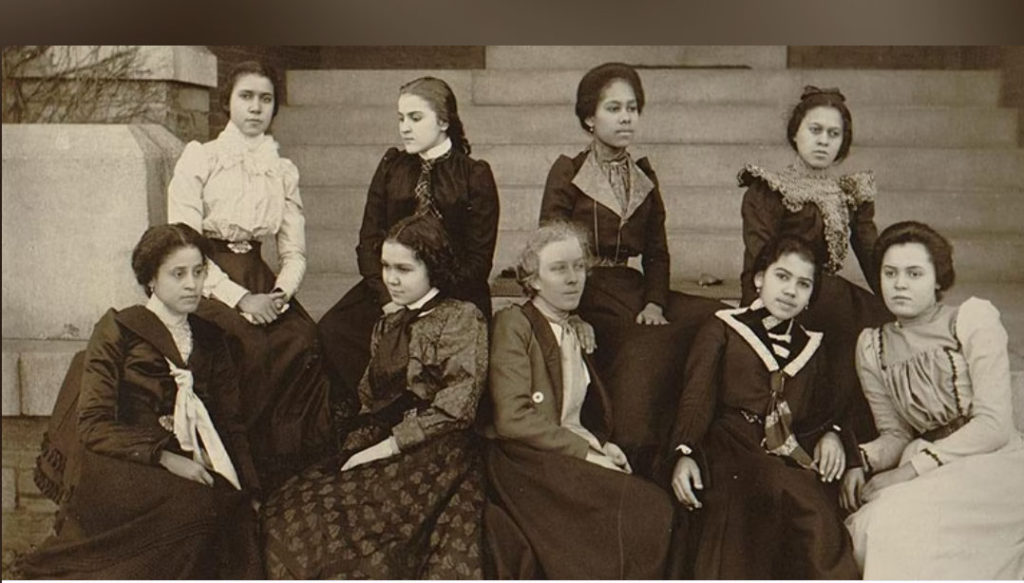 African American women posing in Victorian dress. 