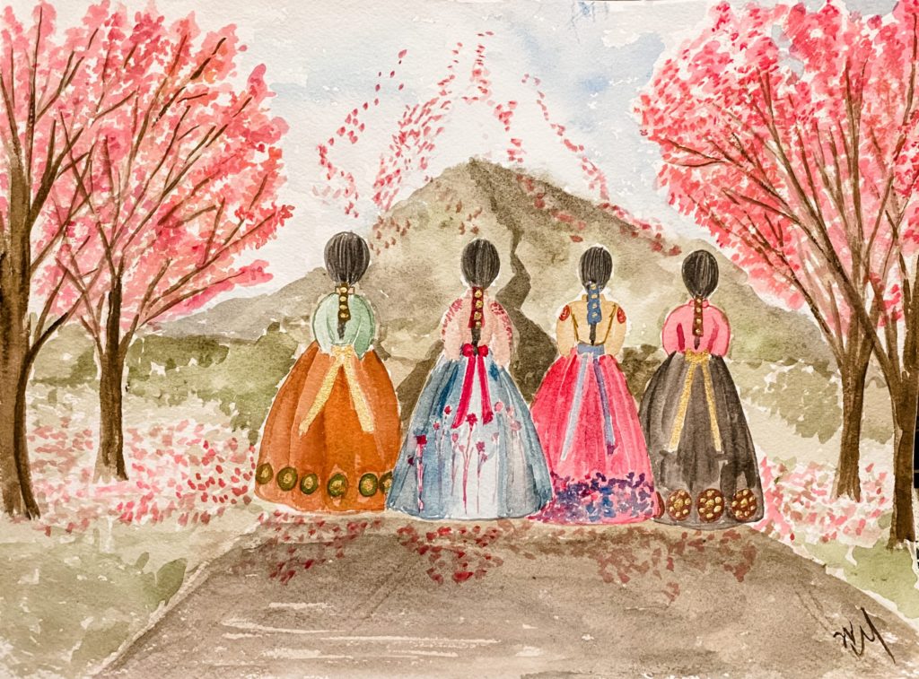 Four Latin American women walking amongst cherry blossoms. 